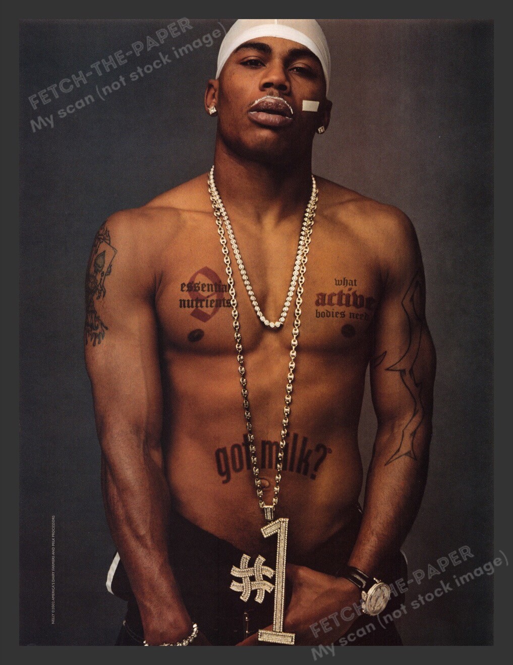 Nelly — shirtless / gold-chain state