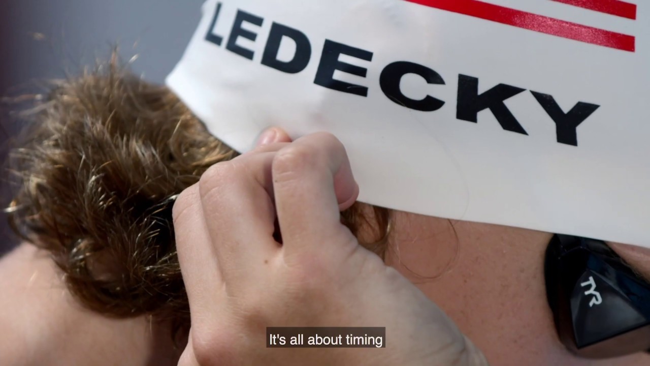 Still from “Katie Ledecky's Training & Recovery Routine” (0:30, November 8, 2019): a swim cap printed LEDECKY