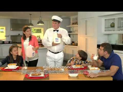 “El Super Desayuno” (not confirmed): a milkman with a gallon of milk at a family breakfast table, elsuperdesayuno.com on screen